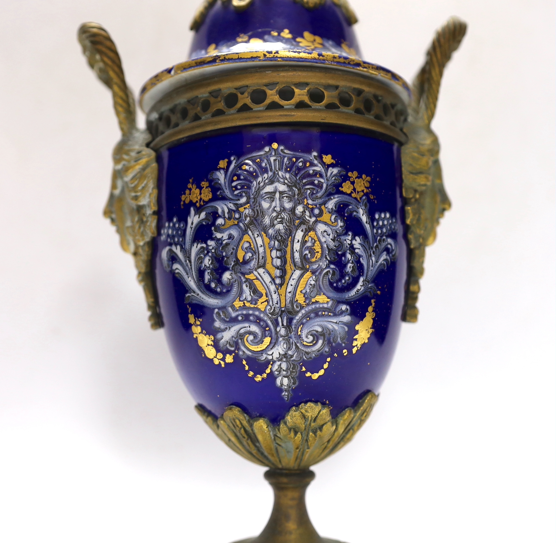 A Limoges style porcelain ormolu mounted urn and cover, 29cm high